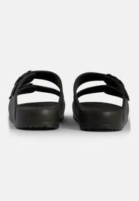 Black rubber sandals with dual top straps and an open back, featuring a textured sole for grip and slight shoe elevation.