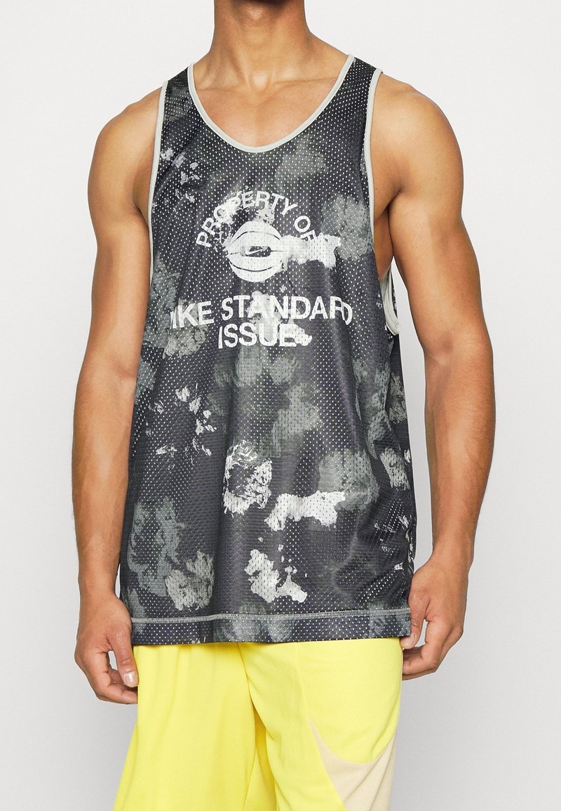 Black and gray mesh tank top featuring a mottled design. White text states "PROPERTY OF" and "LIKE STANDARD ISSUE." Sleeveless, rounded neckline.