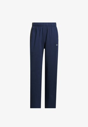 Pantalon de survêtement bleu marine en tissu doux, avec une taille élastique, des bandes latérales et un petit logo sur la partie inférieure gauche de la jambe.