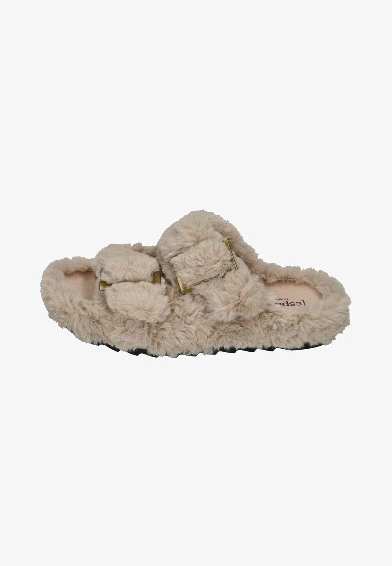 Furry beige slippers with two adjustable straps, soft texture, and a flat black sole. Features gold-tone hardware accents.