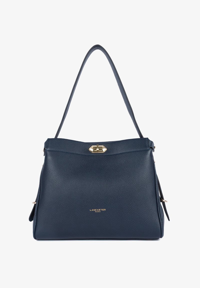 Sac à main en cuir texturé bleu marine avec une seule bandoulière, fermoir tournant doré, et logo "Lancaster Paris" embossé en or sur le devant.