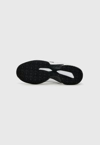 Black rubber outsole with herringbone tread pattern; white midsole with textured accents; sleek design.