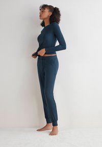 Navyblaues Langarmoberteil und passende Jogginghosen aus weichem Stoff. Mit Rundhalsausschnitt und elastischem Bund mit Kordelzug.