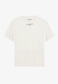 Off-white cotton t-shirt with short sleeves and a relaxed fit. Features a small black text logo on the chest. Smooth texture.