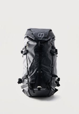Sort og grå vandrerygsæk med gittermønster, flere stropper, spænder og lukning med topklap, mærket "MTN GEN 32+".