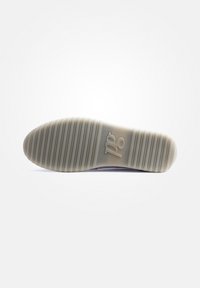 Semelle d'une chaussure, présentant un matériau en caoutchouc texturé de couleur crème clair avec des rainures horizontales et un logo estampé au centre.