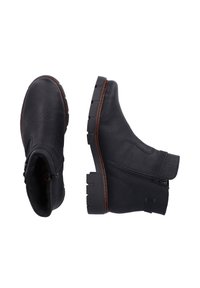 Bottes de cheville en cuir noir avec une surface texturée, fermeture éclair sur le côté et semelle en caoutchouc épaisse. Dotées d'un col rembourré et de coutures contrastantes.