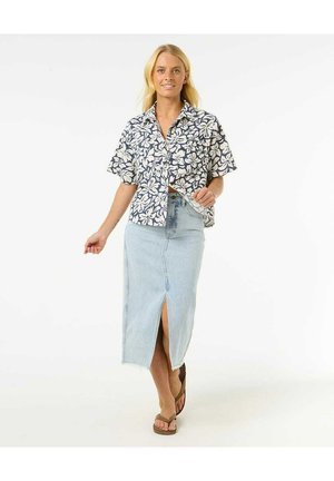 Floral short-sleeve shirt in navy and white, paired with a light blue denim skirt featuring a front slit and frayed hem. Brown sandals worn.