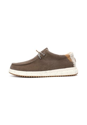 Brown canvas shoe with a round toe, grey laces, and a speckled white sole. Accented with tan leather on the heel. Flat design, slip-on style.