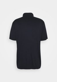 Polo noir à manches courtes avec une texture douce et lisse et un col classique. Design simple sans motifs ni ornements.