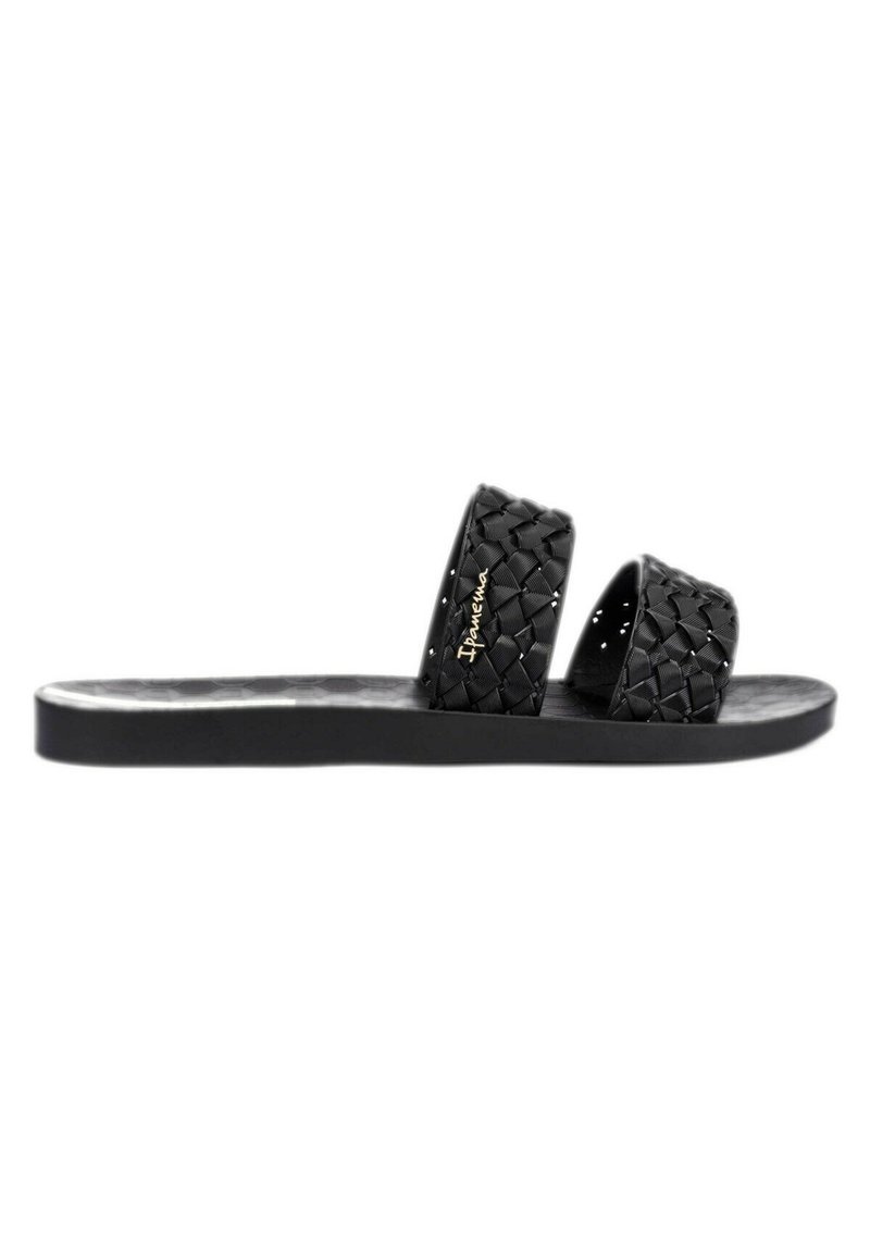 Sandales noires plates avec deux sangles tressées, une semelle lisse et un motif hexagonal sur le pied. Détails de la marque inclus.