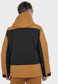 Herrenisolierte Jacke mit Farbblockdesign, braunem Kapuzenbereich und oberem Abschnitt sowie schwarzem Unterteil. Texturiertes Material und verstellbare Bündchen.