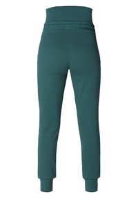 Tyrkysové bavlněné tepláky s širokým elastickým pasem a přiléhavými manžetami na kotnících. Hladký povrch, bez viditelných vzorů nebo ozdob.