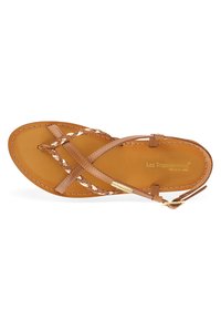 Brown leather sandal with braided straps, circular toe post, and adjustable ankle buckle. Smooth insole with brand logo embossed.