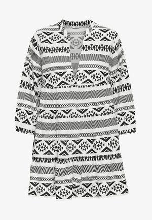 Mustat ja valkoiset kuviotettut tunikat, joissa on geometrisia kuvioita, V-kaula-aukko, kolmennesosa hihat ja kerrostettu helma.