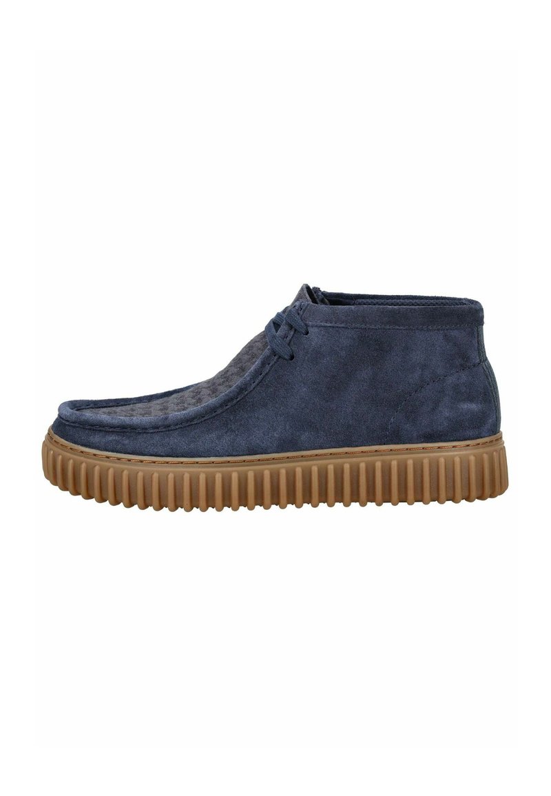 Navy suede ankle boots with a textured surface, rubber sole featuring ridged pattern, and lace detail on the front.