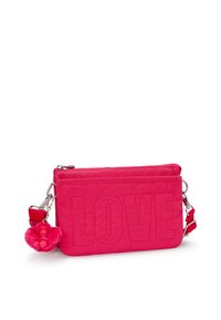 Pink fabric crossbody bag with embossed "LOVE" text, zipper closure, and a detachable fluffy keychain accent. Smooth texture with adjustable strap.