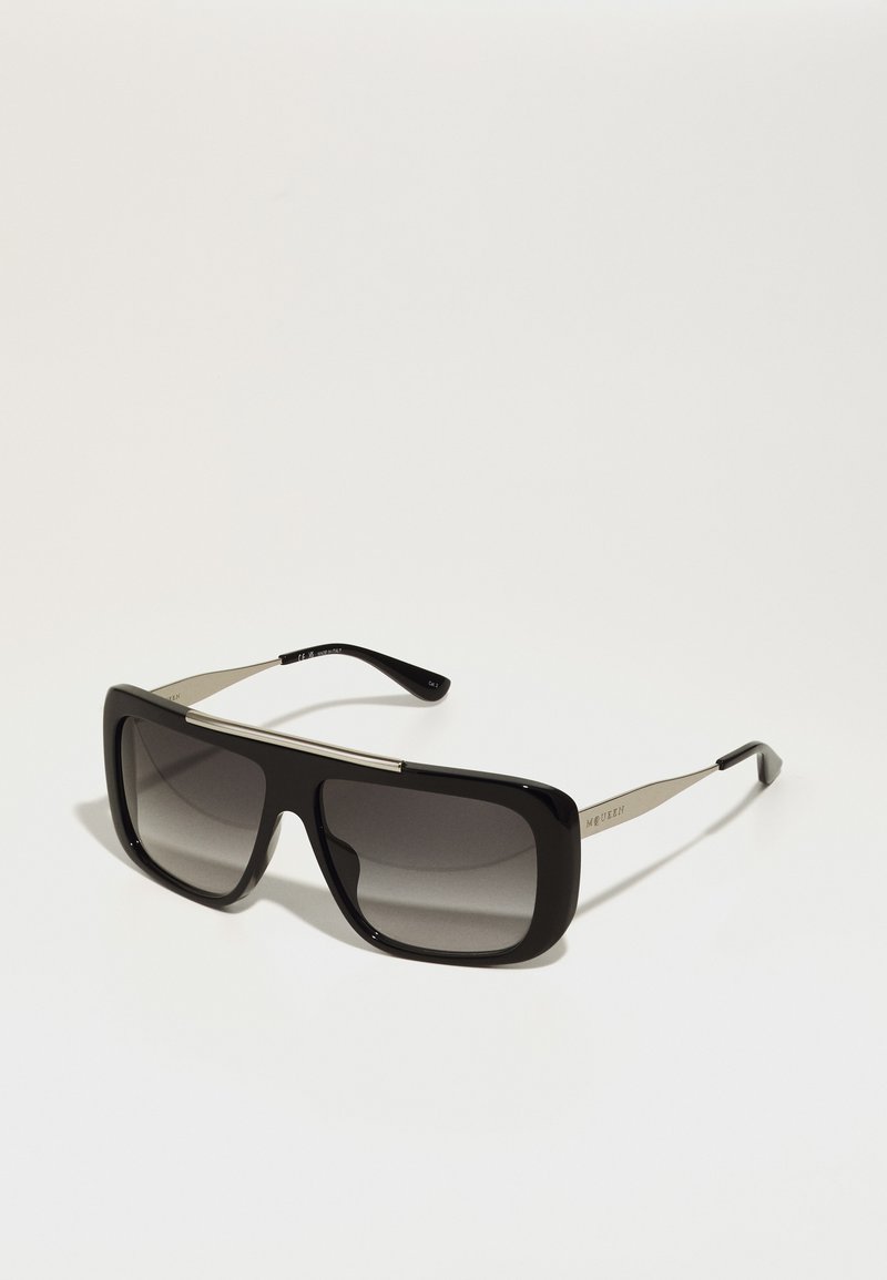 Black rectangular sunglasses with gradient lenses, bold frame, metallic accents, and thin sides. Features a shiny finish and modern design.