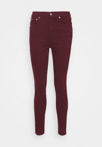 Jean skinny bordeaux en denim, avec une taille haute, cinq poches et une fermeture à bouton métallique. Texture lisse, sans motifs visibles.