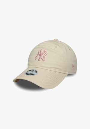 Beige baseball cap with a curved visor, featuring a pink embroidered logo and stitching details. Includes a round tag on the front.