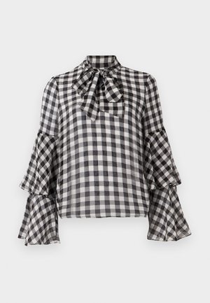 Czarna i biała koszula w kratę z kołnierzykiem w kształcie kokardy, rozszerzanymi rękawami i przezroczystym materiałem. Charakteryzuje się klasycznym wzorem o lekkiej teksturze.