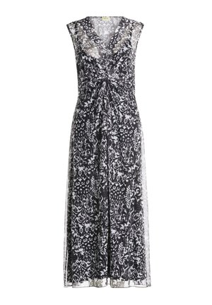 Robe à motifs floraux noir et blanc avec un décolleté en V, sans manches, devant froncé et jupe fluide arrivant mi-mollet.