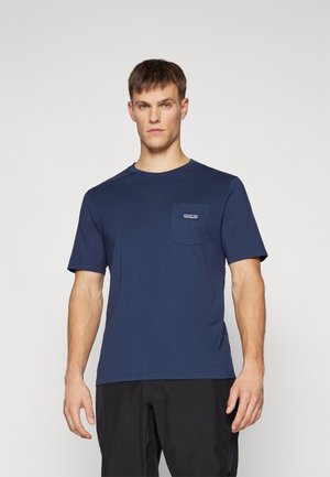 Navy blue cotton t-shirt with short sleeves and a chest pocket. Features a rectangular logo patch on the pocket. Smooth texture.