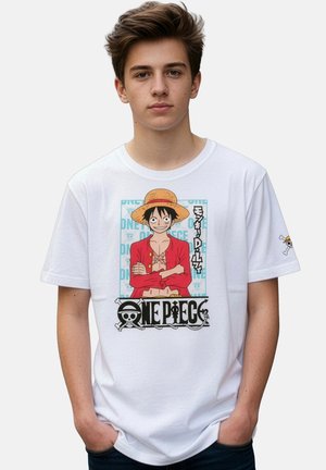 Teenage boy wearing white t-shirt with One Piece anime character in red jacket and straw hat printed on front and sleeve.