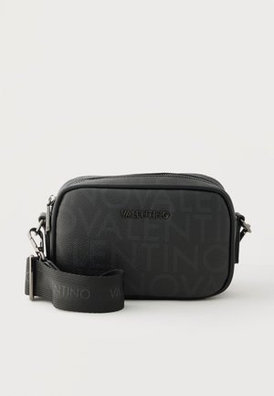 Black Valentino crossbody bag with textured logo pattern, zip closure, and adjustable branded fabric strap on a plain background.