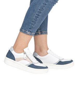 White and blue sneakers feature a mix of leather and suede, a side zipper, and a textured white sole. Worn with cropped blue jeans.