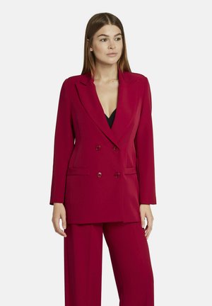 Dubbelzijdige blazer in effen bordeauxrood, met een klassiek revers, twee voorzakken en bijpassende, op maat gemaakte broek. Soepele stoftextuur.