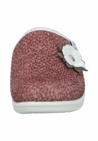 Pink knitted slipper with a rounded toe, white trim, and a decorative fabric flower with green leaves on the side. White sole.