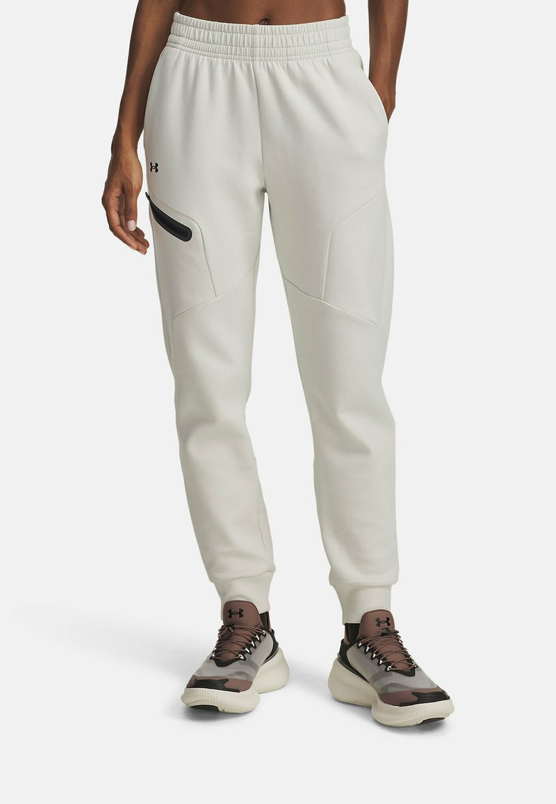 Light gray sweatpants with an elastic waistband, tapered legs, and a side zip pocket, paired with two-tone athletic shoes.