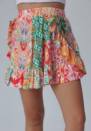 Bunte gemusterte Skirt mit einem Rüschensaum und Rüschenbund. Besitzt pinke, orangefarbene, grüne und lila Designs auf leichtem Stoff.