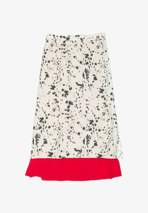 White skirt with black splatter pattern, featuring a red ruffled hem. Soft fabric with elastic waist, knee-length design.