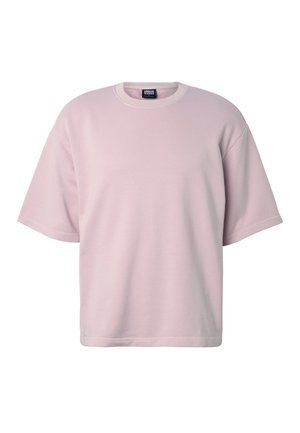 Jasnoróżowy, oversize t-shirt z krótkim rękawem i okrągłym dekoltem, z prążkowanym kołnierzem i metką Urban Classics wewnątrz przy szyi.