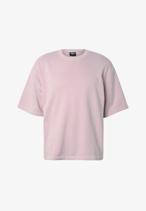 Jasnoróżowy, oversize t-shirt z krótkim rękawem i okrągłym dekoltem, z prążkowanym kołnierzem i metką Urban Classics wewnątrz przy szyi.
