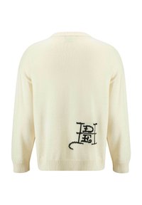 Maglione a maglia color crema con maniche lunghe, polsini e orlo a coste, e un motivo astratto nero sul retro.