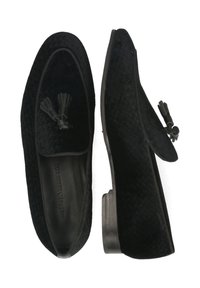 Mocasines negros con un upper texturizado, que presentan un detalle de borlas y un tacón bajo y redondeado. Forro interior suave para mayor comodidad.