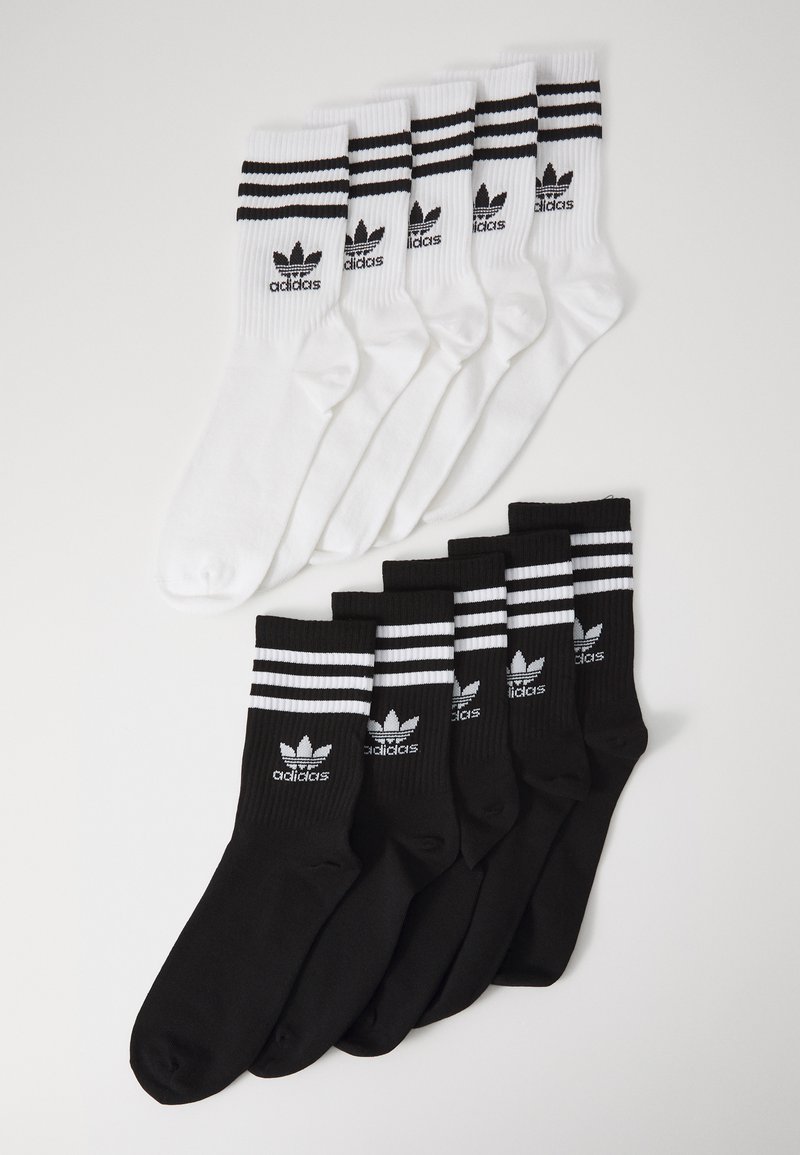 Lot de 6 chaussettes : 3 blanches avec des rayures noires et logo, 3 noires avec des rayures blanches et logo. Mélange de coton, longueur mi-mollet, design athlétique.