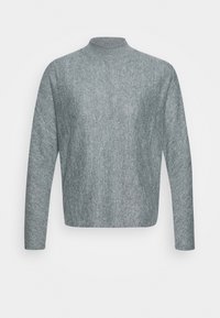 Light gray sweater with a high neckline, long sleeves, and a soft texture. The design is minimalist with a relaxed fit.