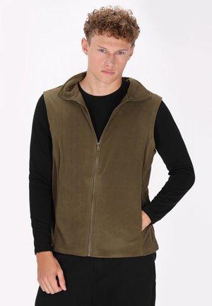Olivengrønt fleece vest med fuld lynlås, høj krave og uden ærmer, parret med en sort langærmet skjorte nedenunder.