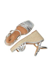 Sandalias de cuña plateadas con tiras, con un upper metálico texturizado y una plataforma de yute trenzado, que presentan una punta cuadrada y correas de tobillo ajustables.