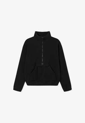 Black fleece pullover with a high collar, half-zip front, and a large front pocket. Features a soft texture and relaxed fit.