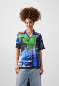 Short-sleeve button-up shirt featuring vibrant graphics of a car and a panther, with a green striped pattern, predominantly blue and black colors.