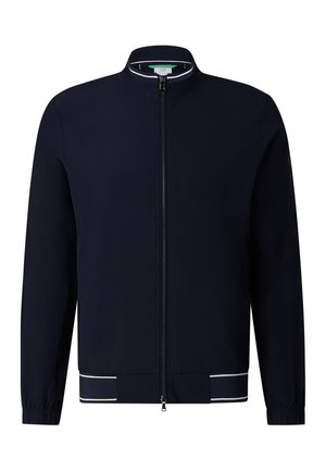 Marineblå lynlåsskjortejakke med ståkrave, elastiske manchetter og hvide accentstriber på kanten mod en hvid baggrund.