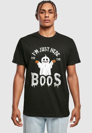 Sort bomulds T-shirt med et spøgelse-tryk, græskar og teksten "JEG ER BARE HER FOR ØLENE" i hvidt, drippy skrifttype. Korte ærmer.