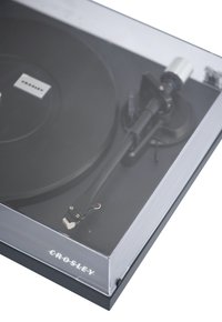 Crosley turntable with a black platter, clear cover, and black tonearm. Notable details include hardware and colored wiring.