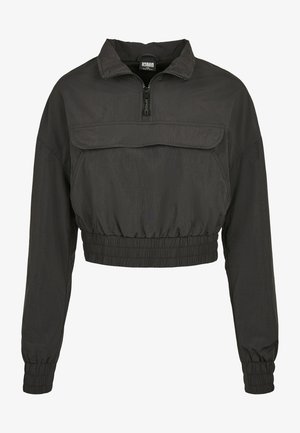 Afgebroken zwarte windbreaker met een hoge kraag, rits aan de voorkant en elastische tailleband en manchetten. Voorzien van een voork pocket.