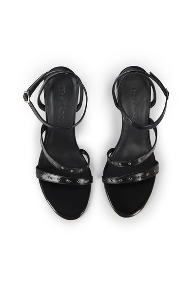 Pair of black leather open-toe sandals with thin ankle and toe straps featuring small metal eyelets, shown from top view on white background.